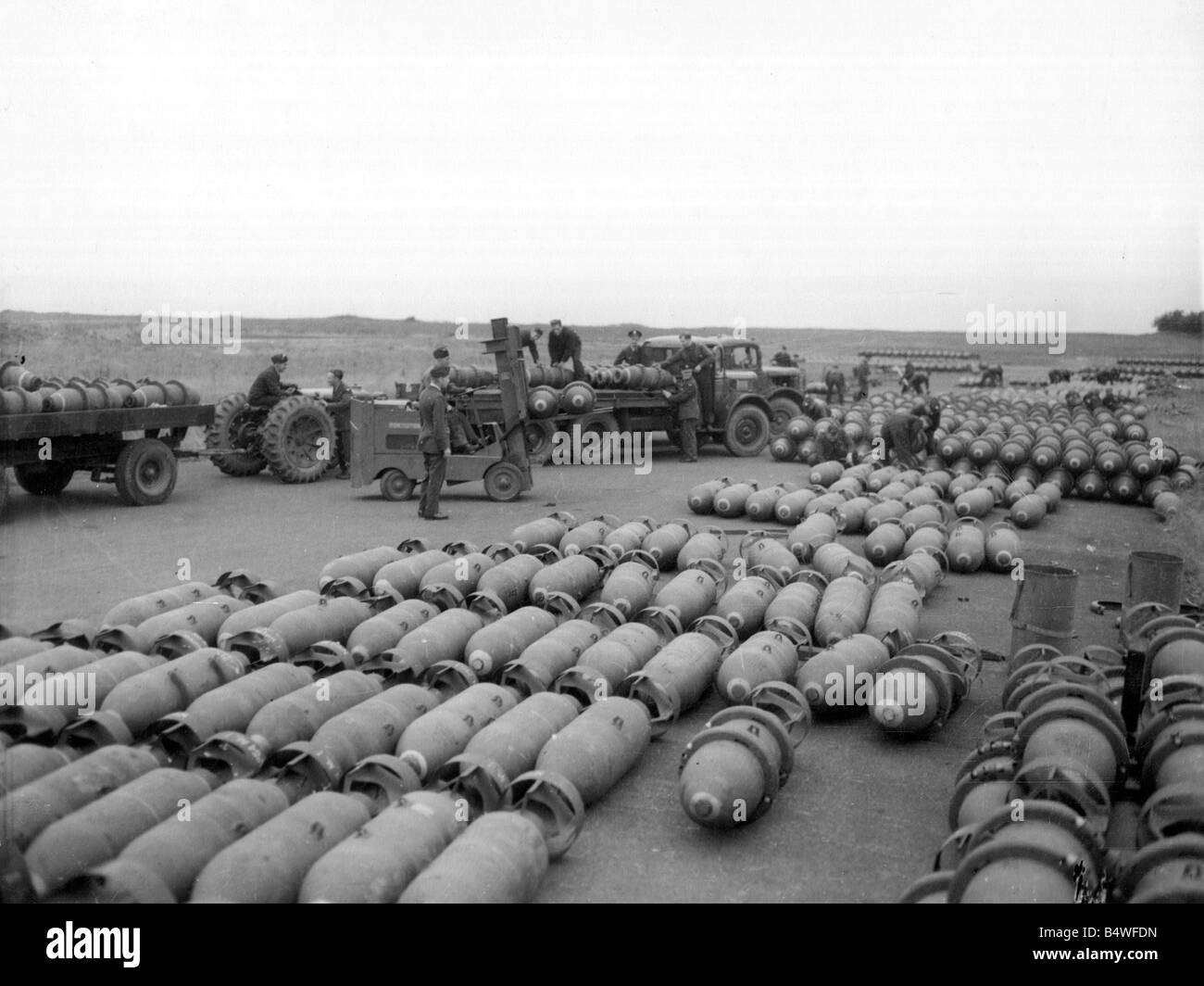 Loaded bomb trains leaving the dumps at an RAF Bomber Command Station during preparations for another attack in support of the Allied Armies in Northern France during World War Two June 1944 Stock Photo