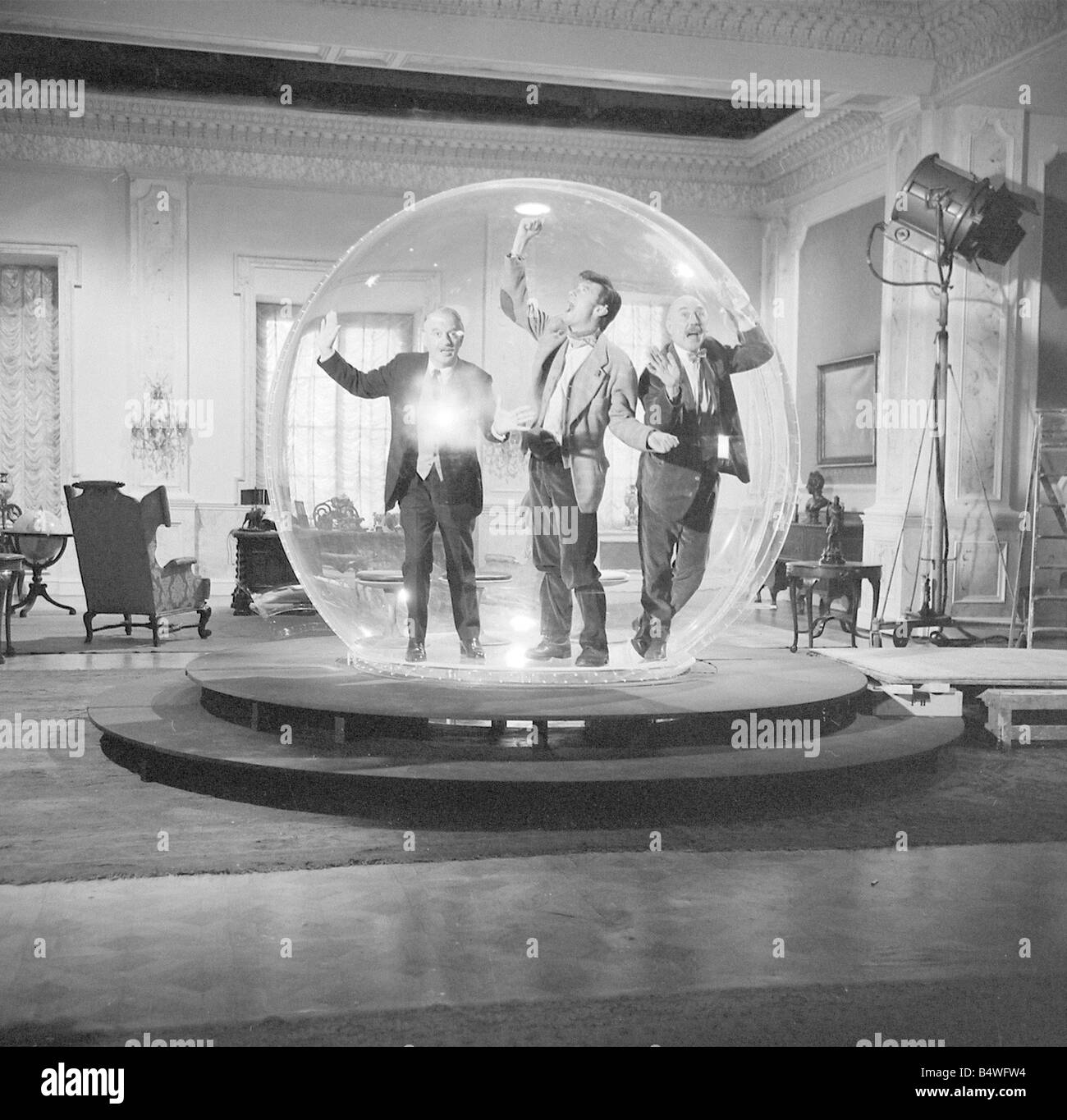 Left to right Eric Portman Laurence Harvey and Lionel Jeffries seen here on the set of The spy with a cold nose at Shepperton Studios The actors are seen here in The dome an anti bugging device constructed of perspex and 9 foot in diameter In the film the three actors get locked inside the device July 1966 W7237 Stock Photo
