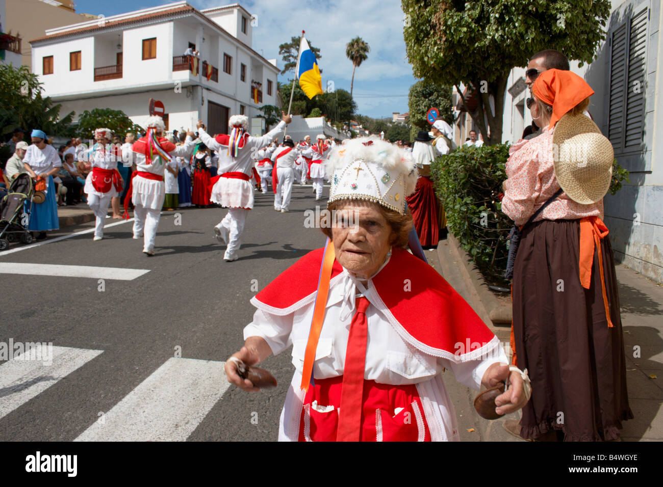 Los Bailarines (dancers) from El Hierro in traditional red and white costume dancing at local fiesta Stock Photo