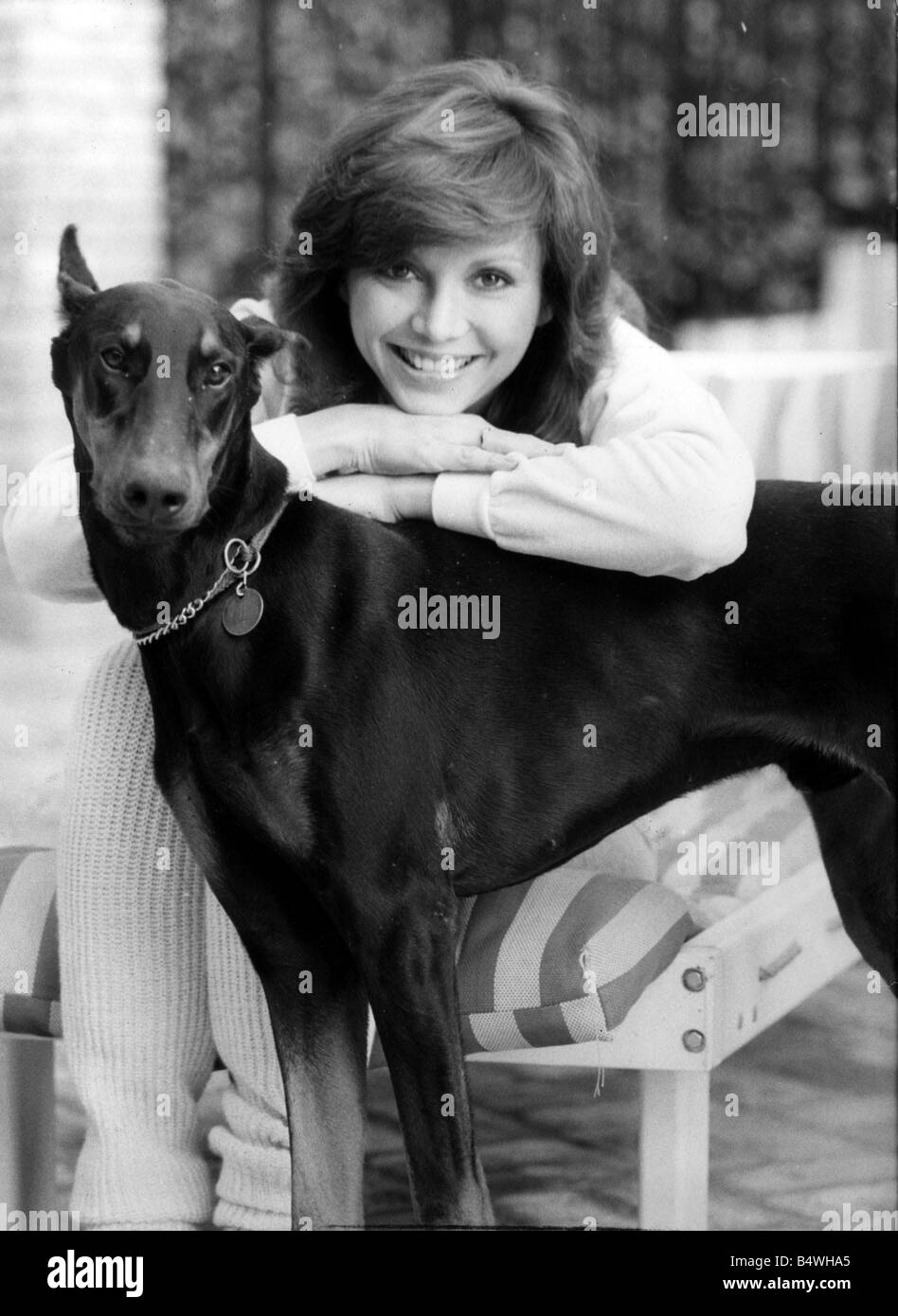 Victoria Principal Actress leaning on Dobermann Dog Stock Photo