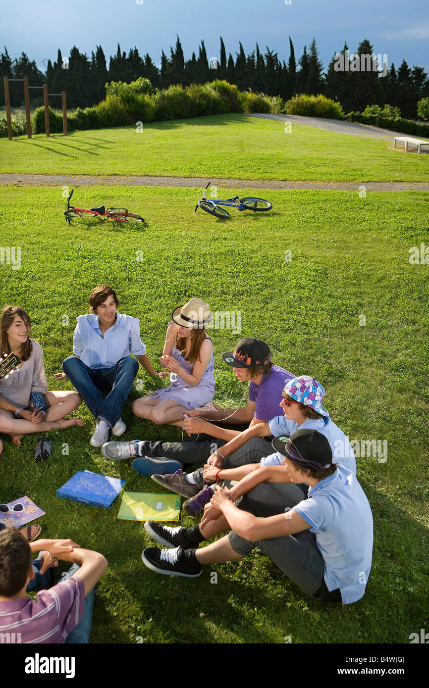 Teen group sitting on grass Stock Photo - Alamy
