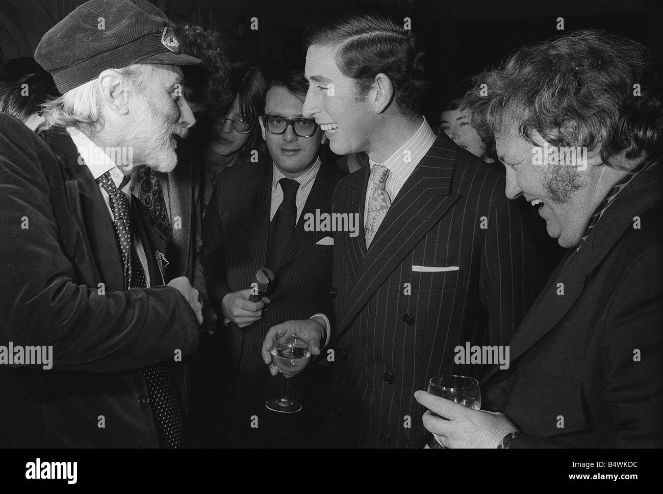 Prince Charles laughs merrily with two of his heroes Harry Secombe and Spike Milligan at the launching of their new Goons book at the Eccentric Club in London Reporters Paul Callan and Janet Street Porter listen in on the conversation November 1973 Y2K Fame dtgu2 dtgu2 Stock Photo