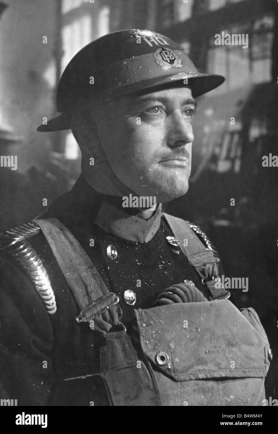 A member of the London Fire Brigade seen here during the blitz World War II Uniform Tin Helmet Breathing Apparatus Home Front Air Raids Fireman Firefighter Circa 1941 Mirrorpix Stock Photo