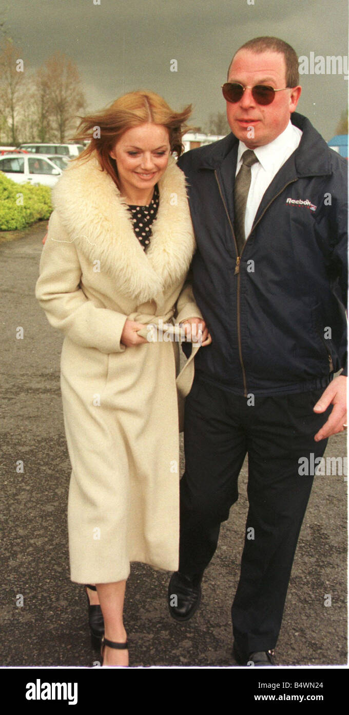 Geri Halliwell Ginger Spice in fur trimmed coat walks to the helicopter as she prepares to leave with the other members of the spice girls from Elstree Aerodrome on a helicopter for tea at Highgrove Hall with Prince Charles and Prince Harry April 1998 Stock Photo