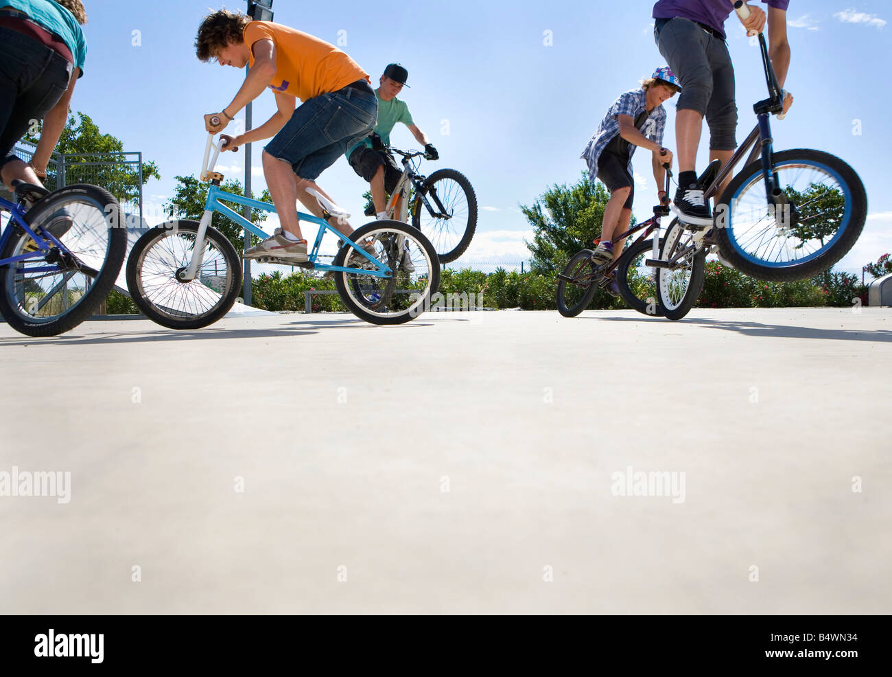 Teen boys on bikes jumping Stock Photo - Alamy