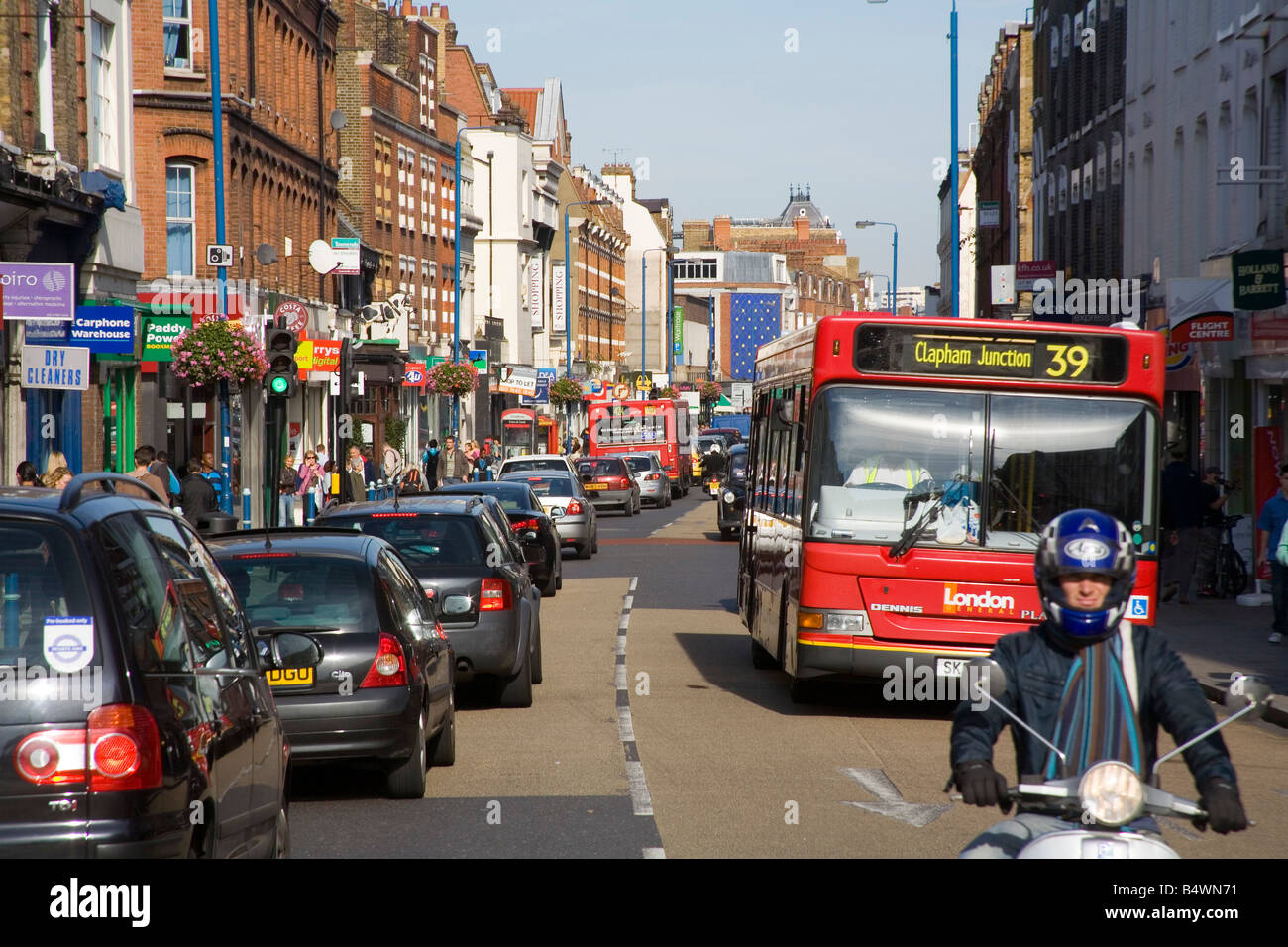 Traffic and shops in busy Putney High Street London Stock Photo