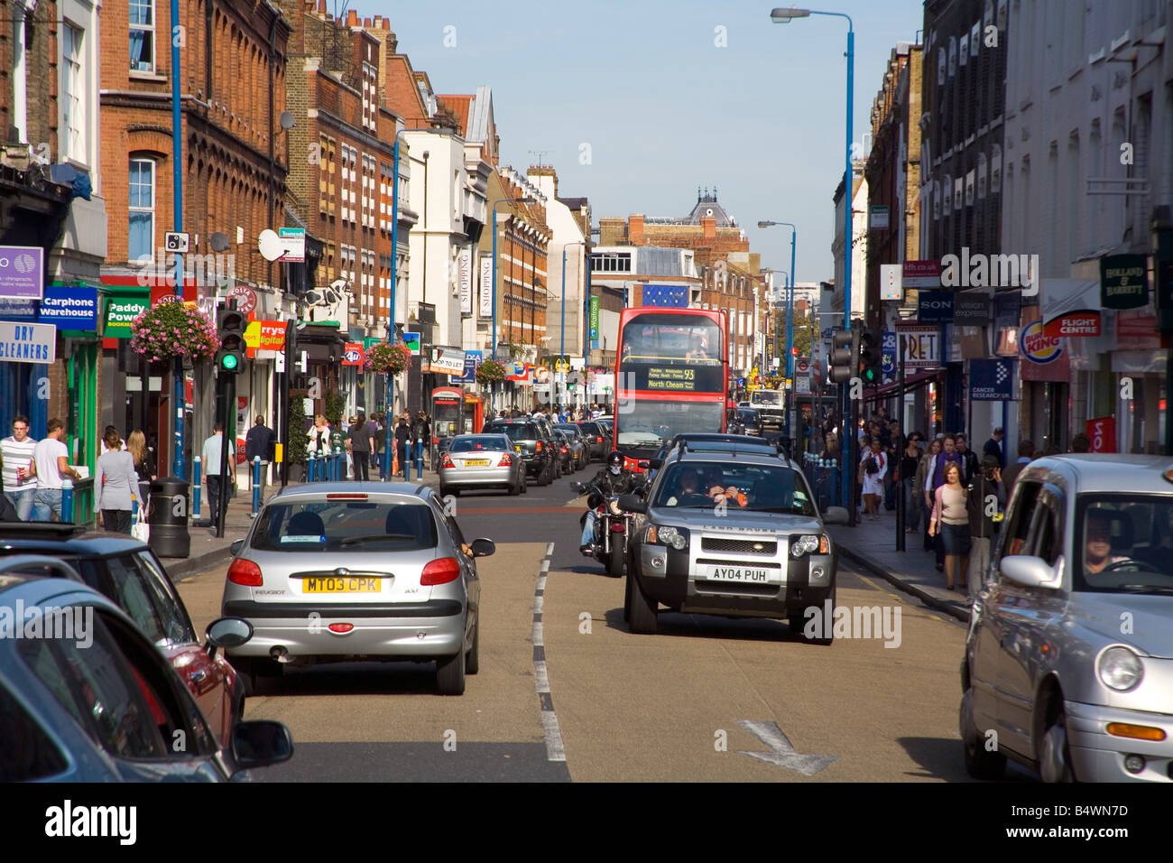 Traffic and shops in busy Putney High Street London Stock Photo