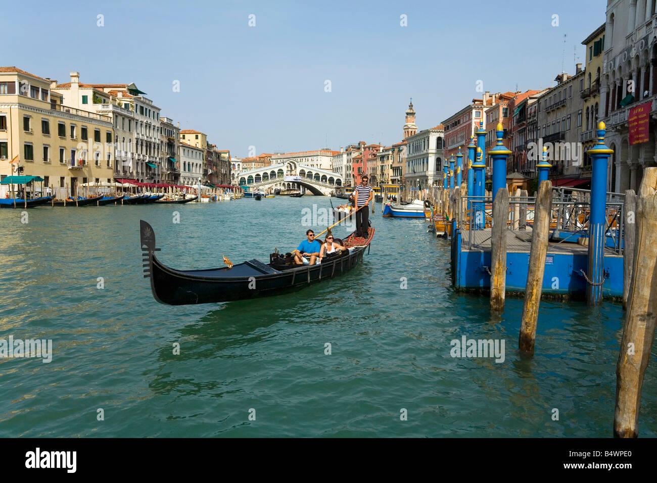 Taking a Gondola ride near the Rialto Bridge in Venice Italy Stock Photo