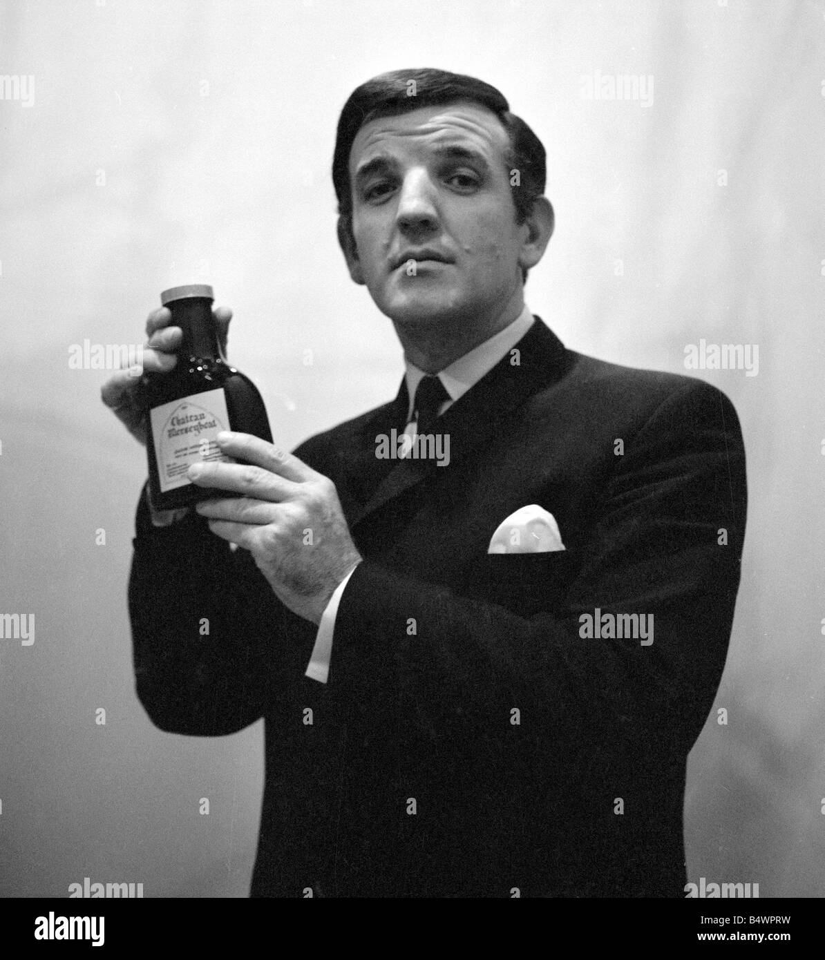 Radio DJ Alan Freeman holding a bottle of Mersey water&#13;&#10;February 1964 Stock Photo
