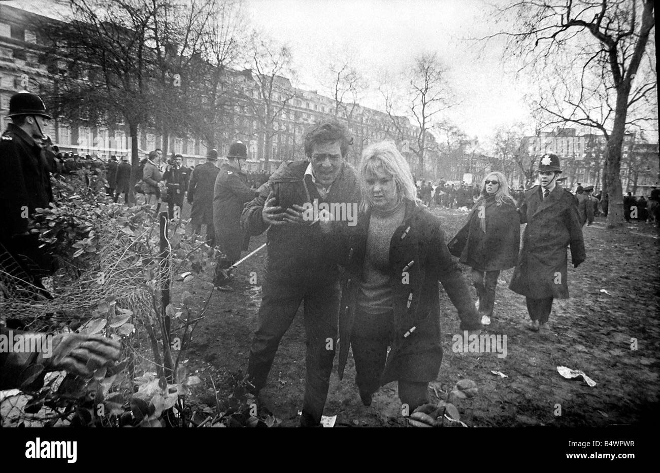 A demonstrator is led away during riots at US 'Embassy,' Grosvenor 'Square,' over the on-going Vietnam Conflict. March 1968 Stock Photo