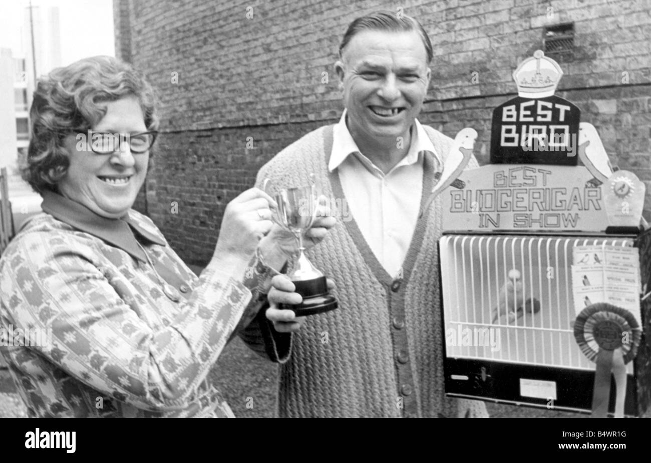Mrs Edna Stott, wife of the Bird show manager, presenting Mr Jack Hall with his trophy for 'Best In Show' at Rugby Cage Bird Society's charity show. ;21st September 1974; Stock Photo
