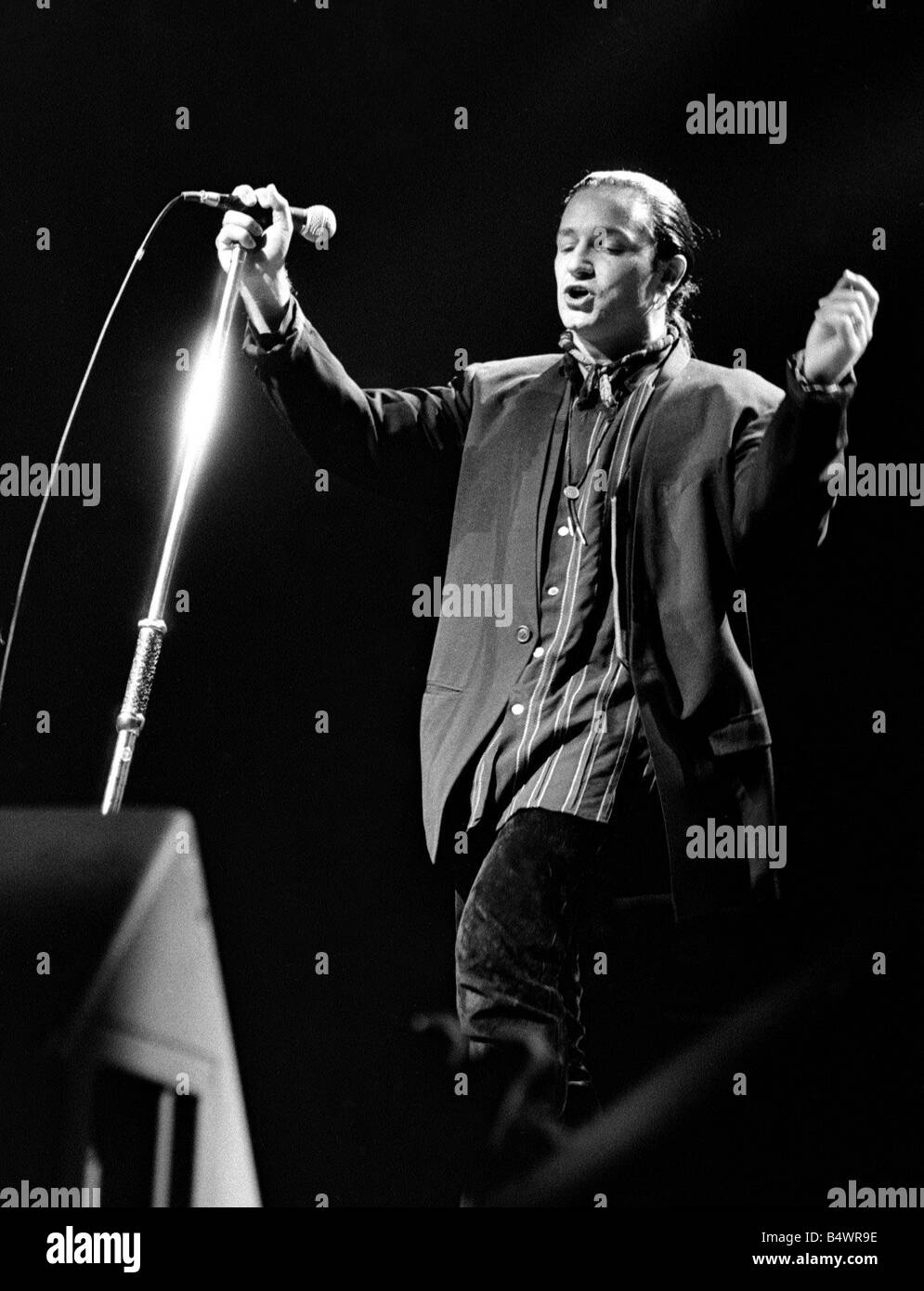 Rock group U2 in concert in USA May 1987 Bono singing and playing guitar Stock Photo