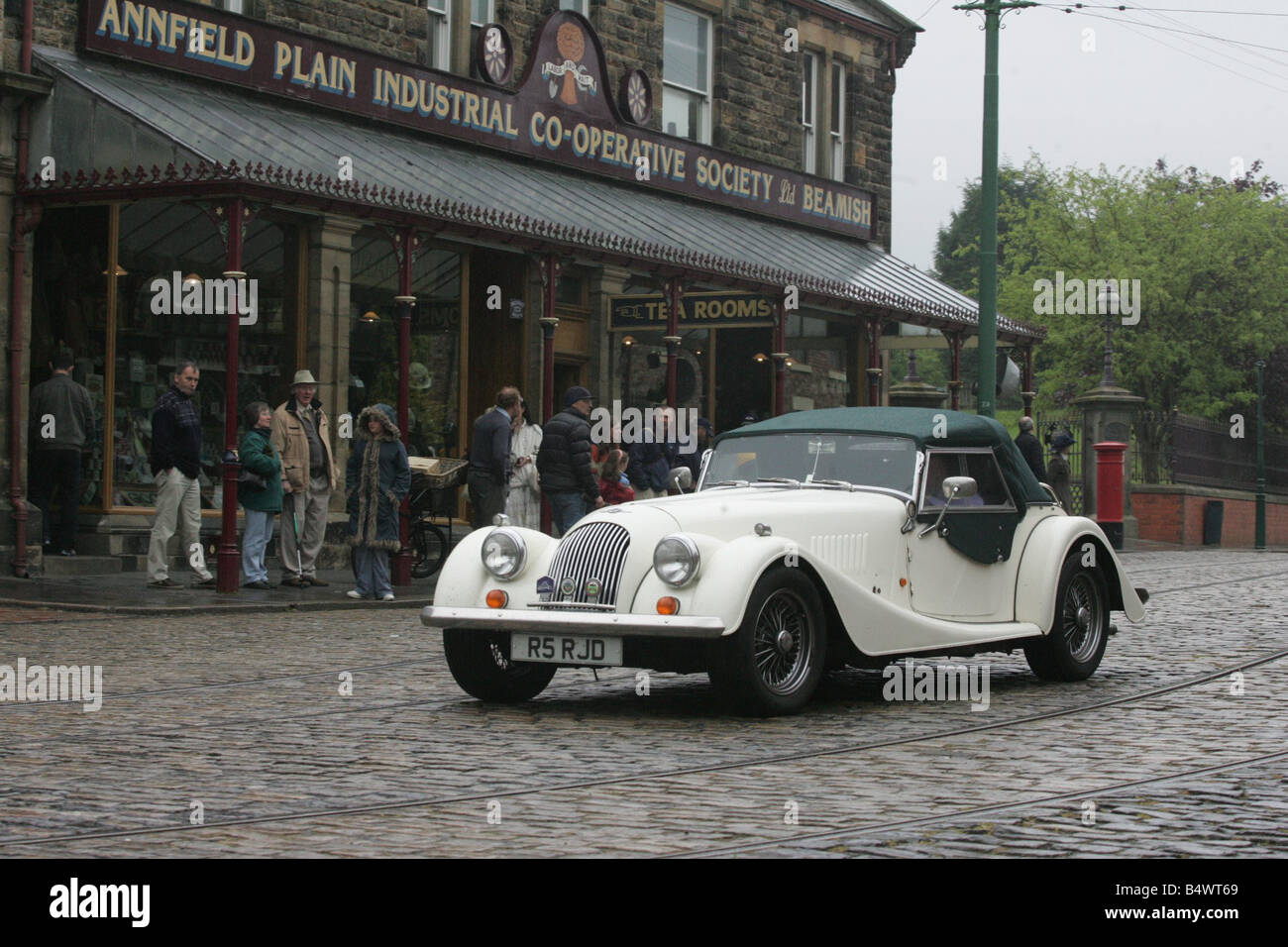 Vintage Morgan motor cars parade through the old town at Beamish after exhibiting over the weekend Stock Photo
