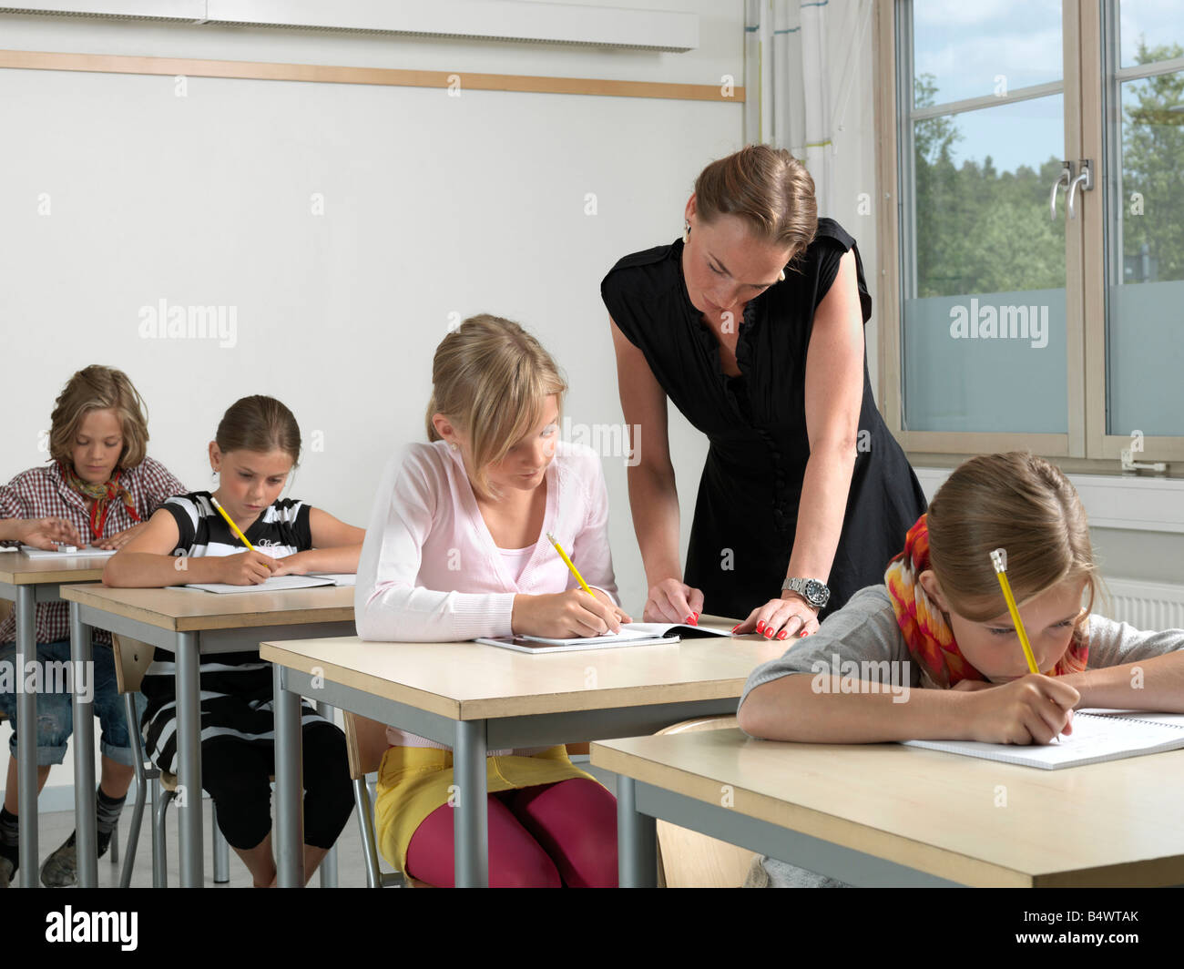 Teacher and students in a classroom Stock Photo