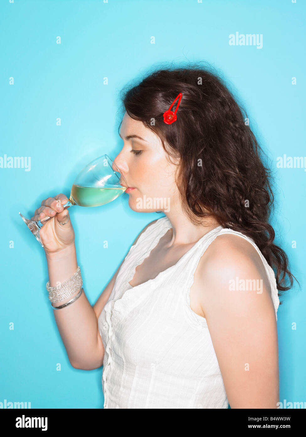 Young woman sipping white wine Stock Photo