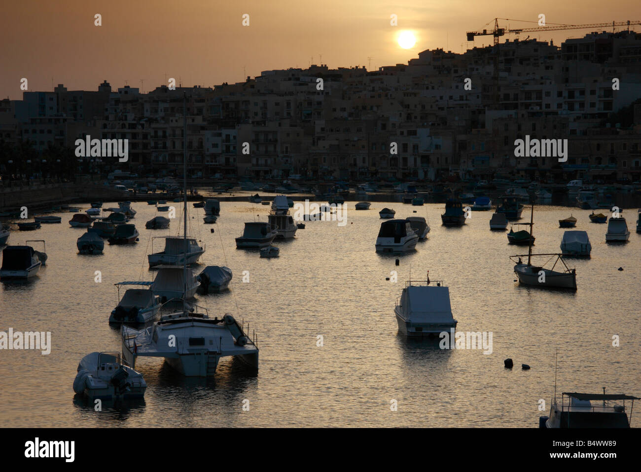 The sun setting over Marasakala harbour in Malta. Stock Photo