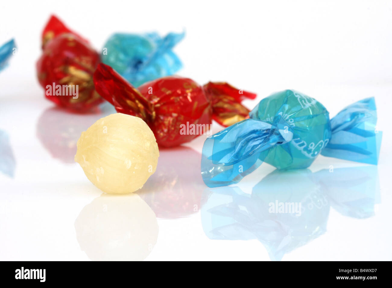 closeup red sugar candy with reflection and defocus candies in