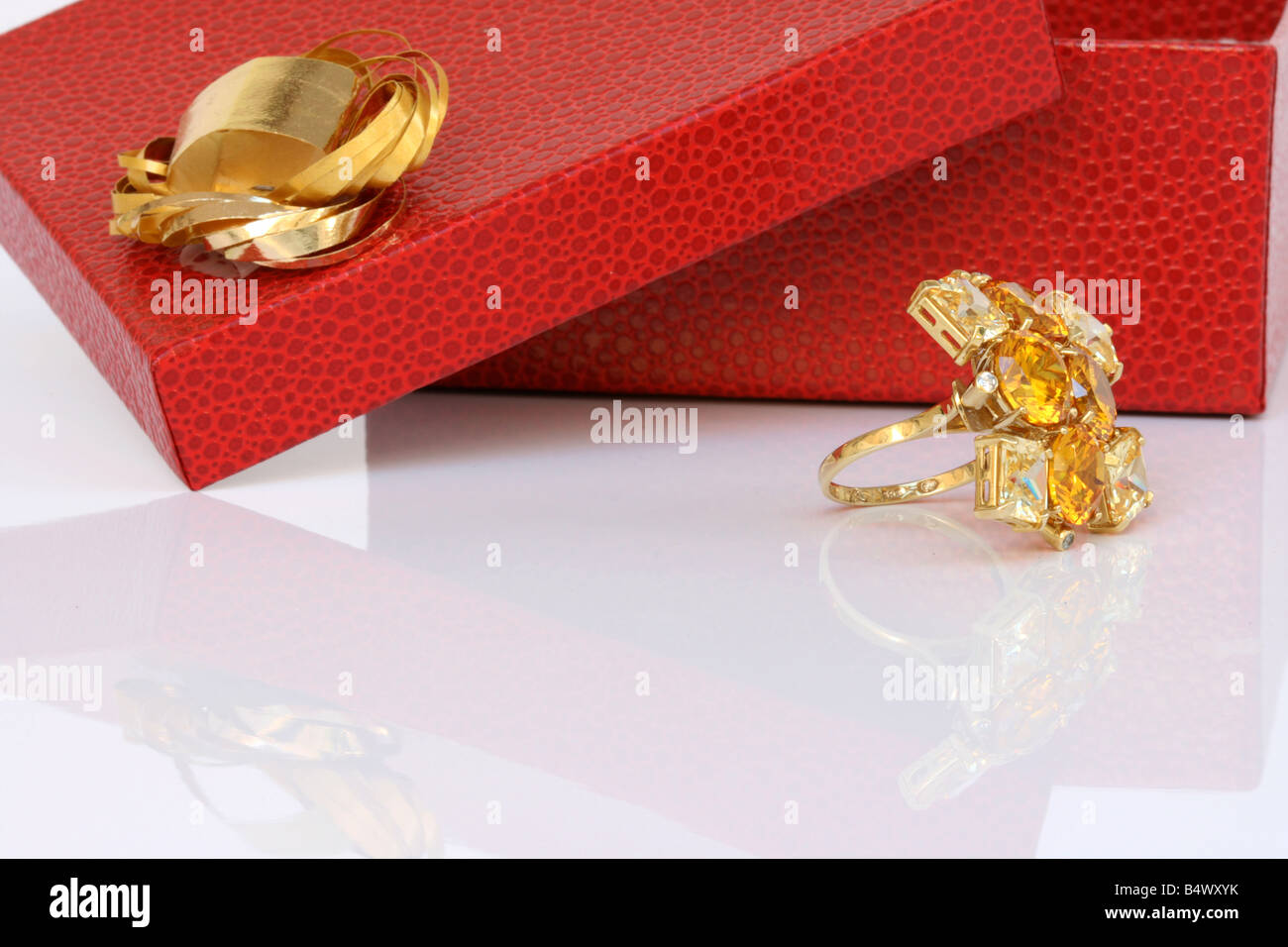 open red gift box and gold ring with reflection Stock Photo
