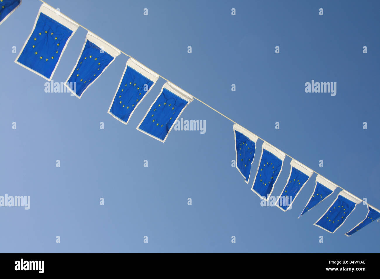 many european union flags flying in wind in sun Stock Photo - Alamy