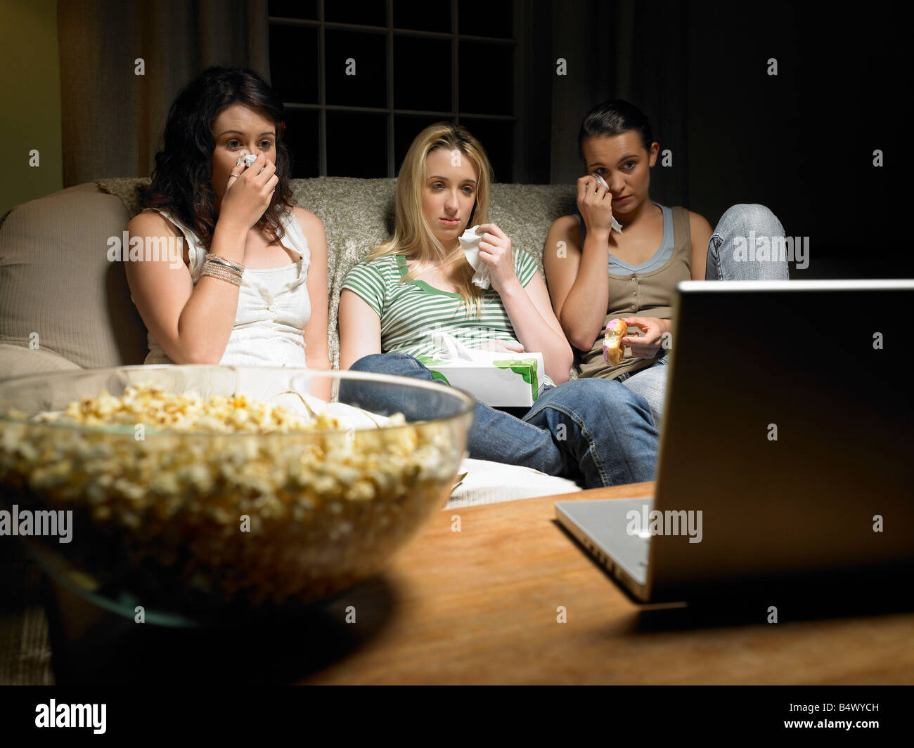 Three young women watching a movie Stock Photo