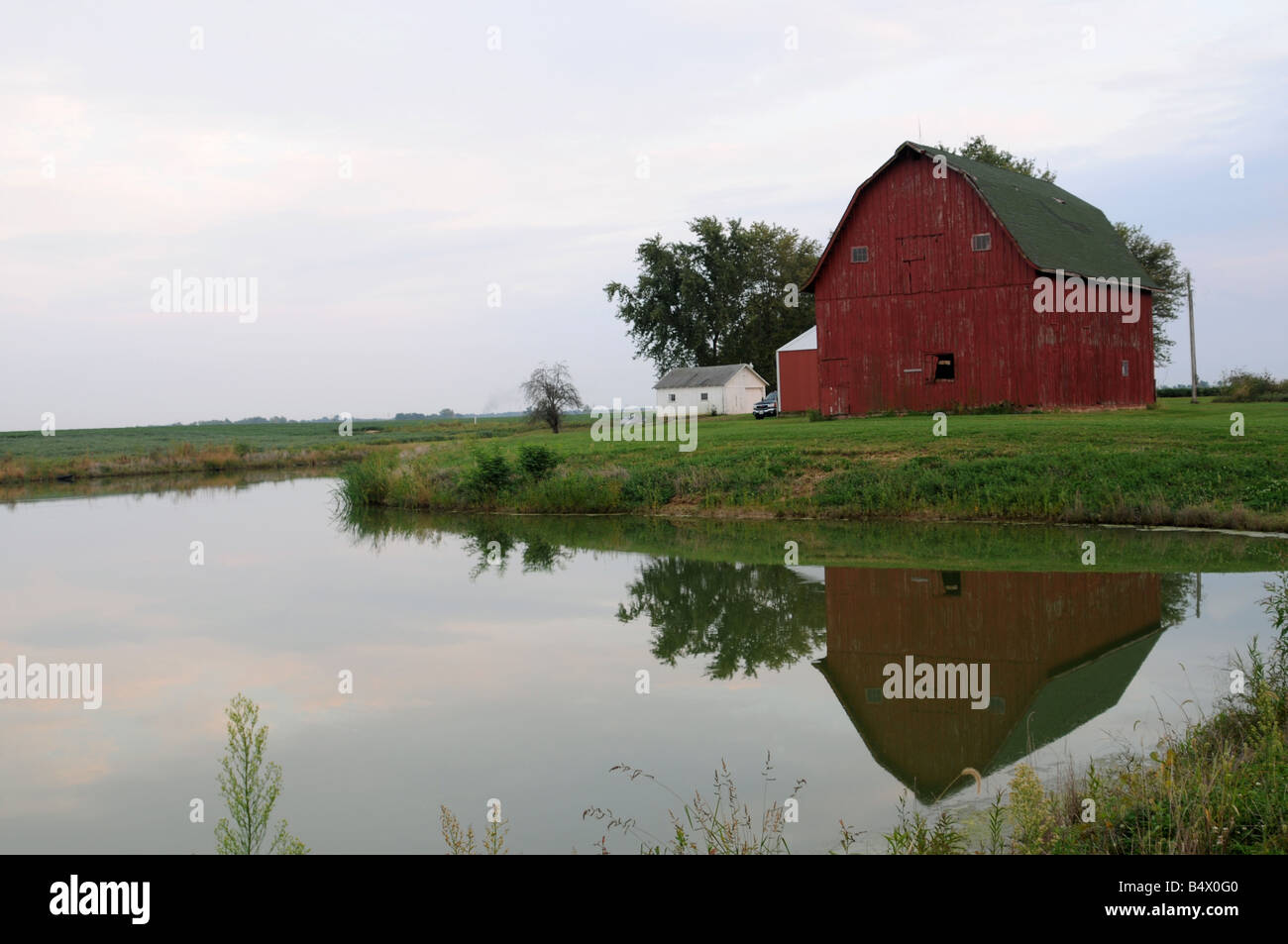 Old Red Barn reflecting in Pond Illinois usa Stock Photo