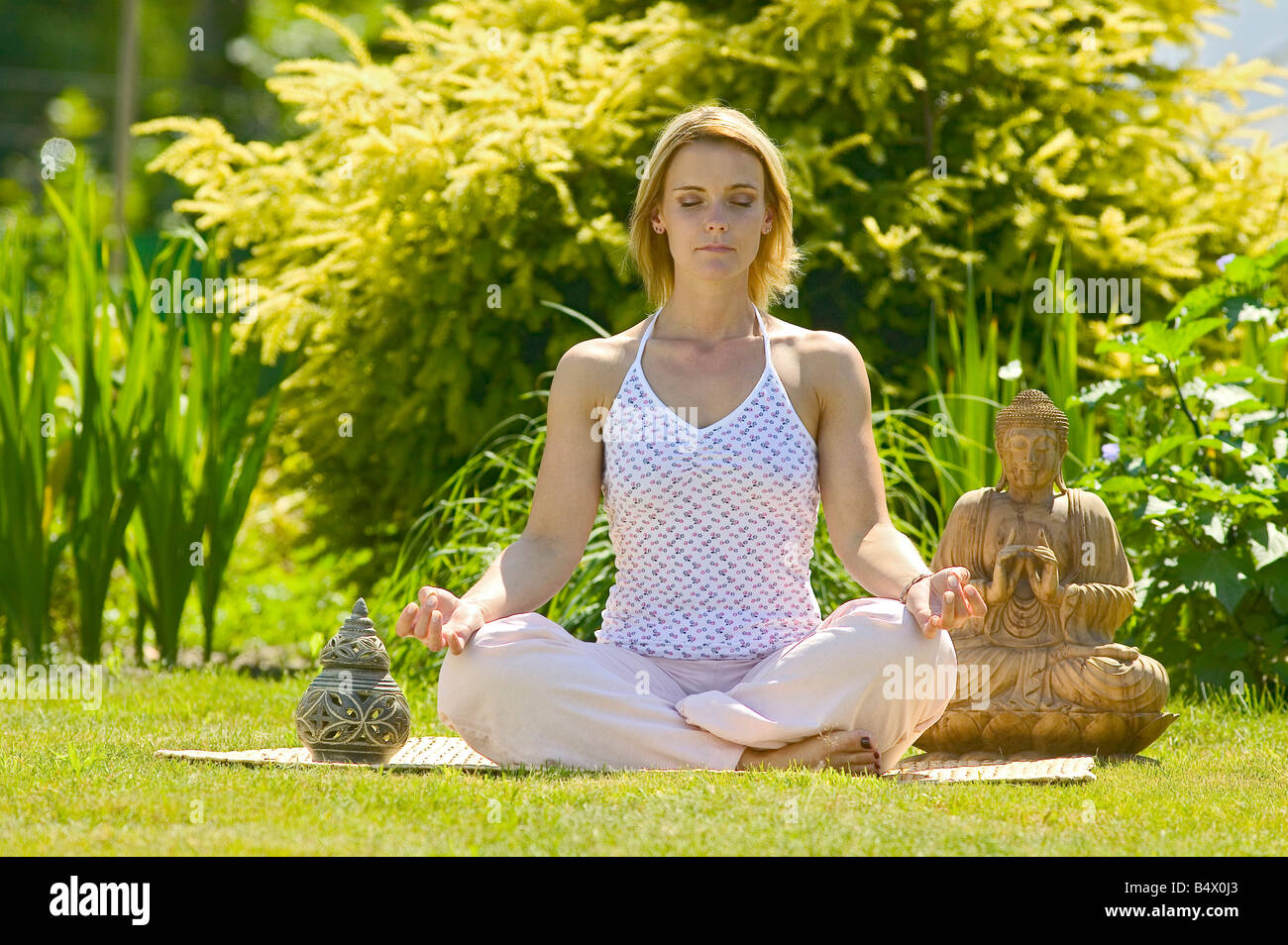 woman meditating in the garden Stock Photo