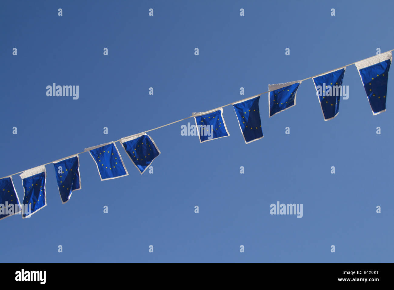 many european union flags flying in wind in sun Stock Photo - Alamy