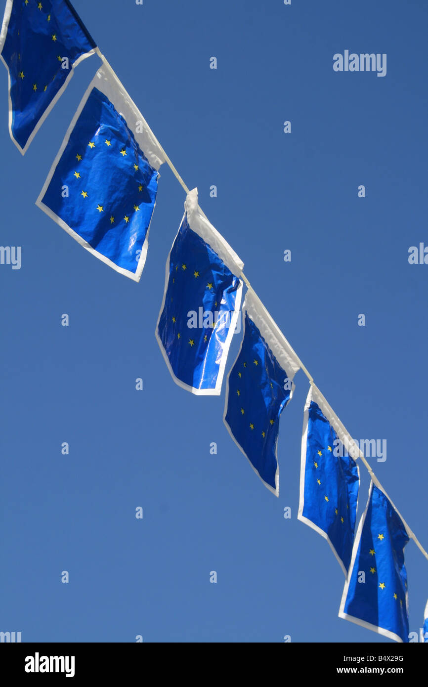 many european union flags flying in wind in sun Stock Photo - Alamy