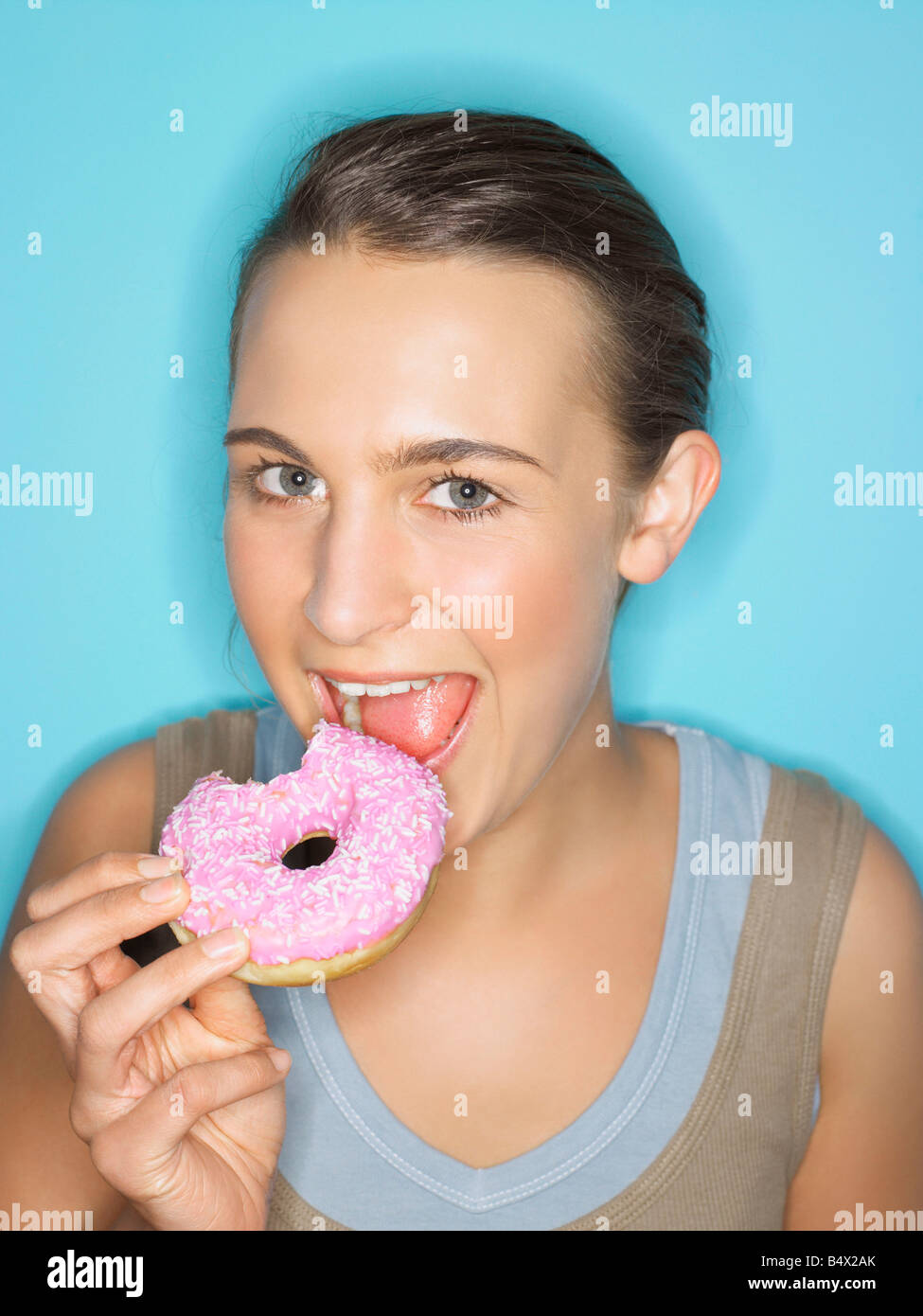 Young woman eating doughnut Stock Photo