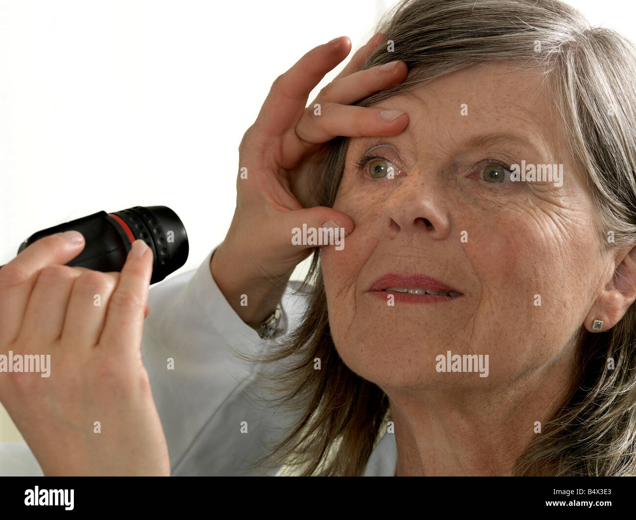 Doctor examining mature woman Stock Photo