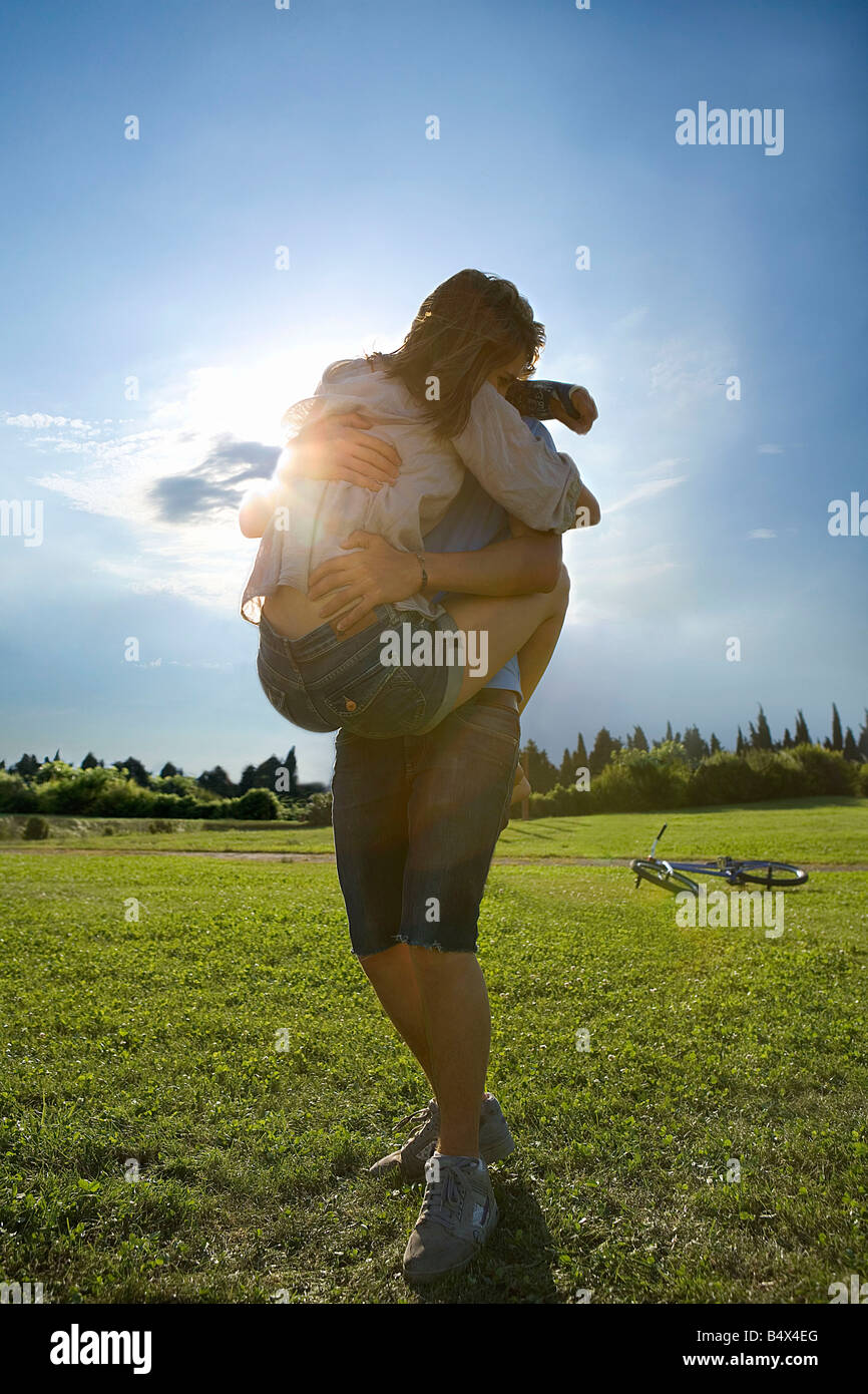 Teen lovers hug in park Stock Photo