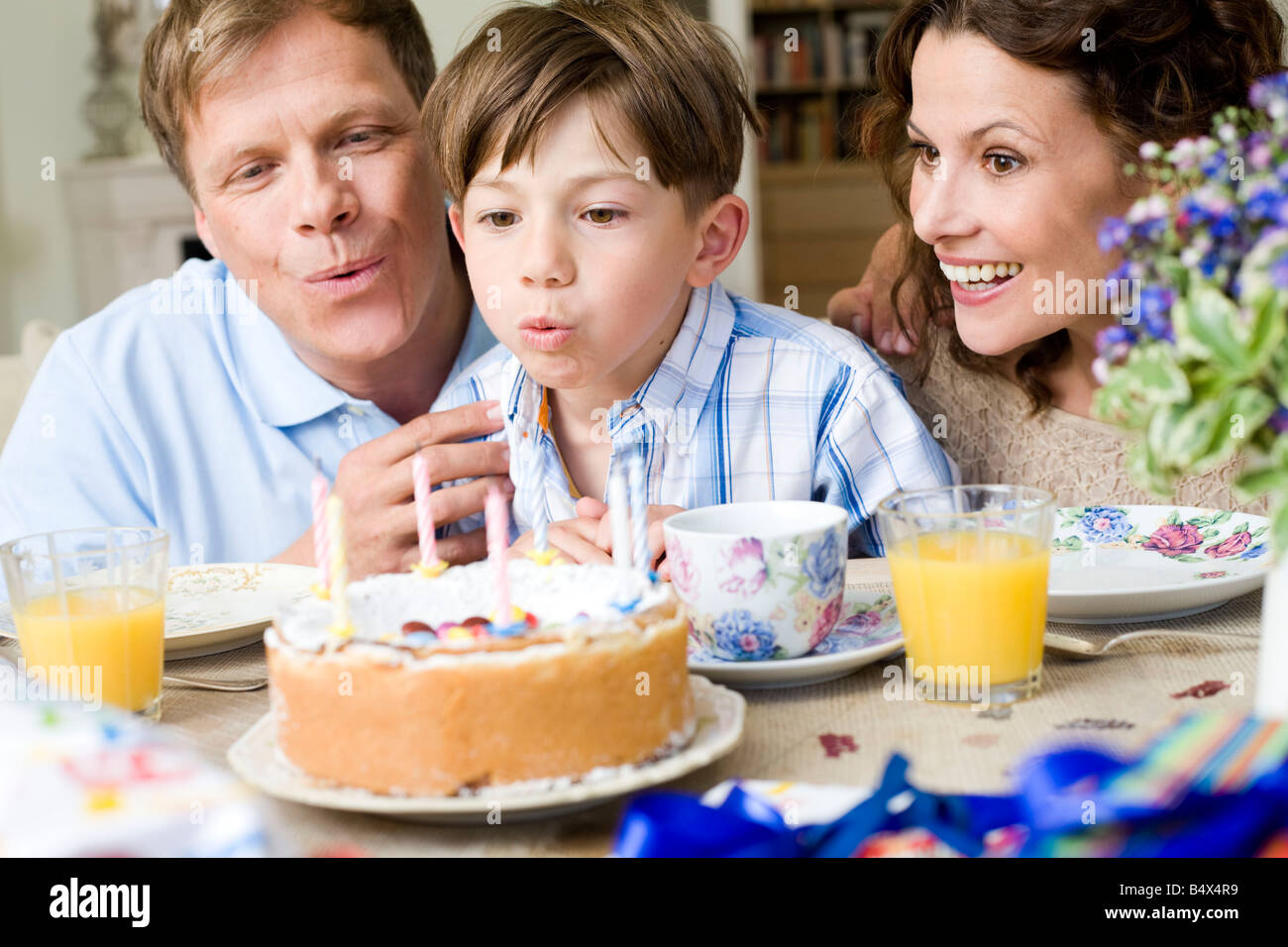 Boy blow out his birthday candles Stock Photo Alamy