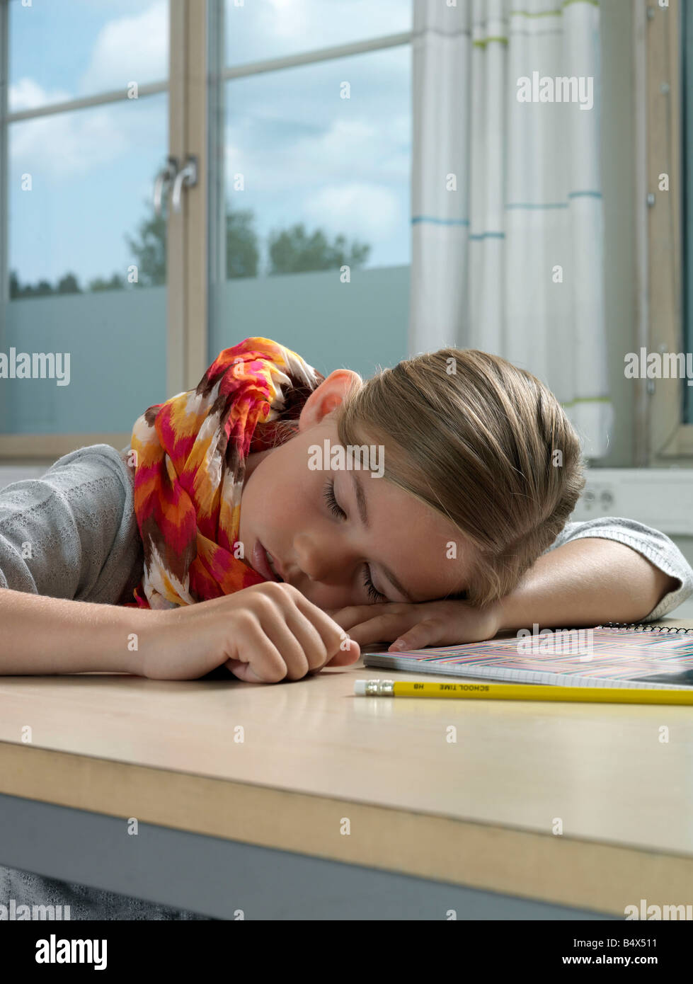 Girl resting on school table Stock Photo