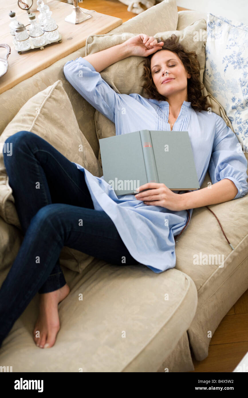 Woman sleeping on a couch Stock Photo Alamy