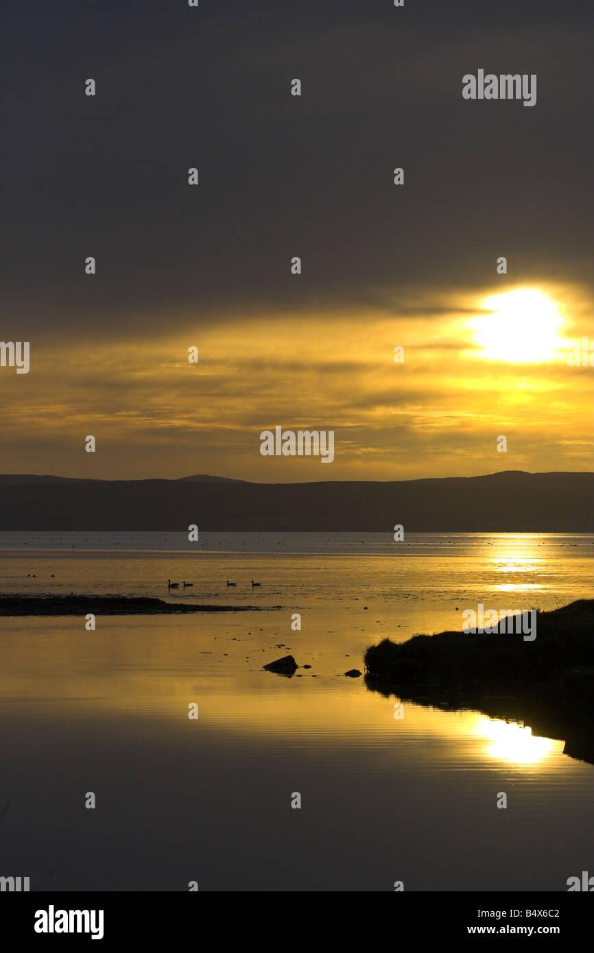 Sun setting over Loch Indaal, Islay, Scotland Stock Photo