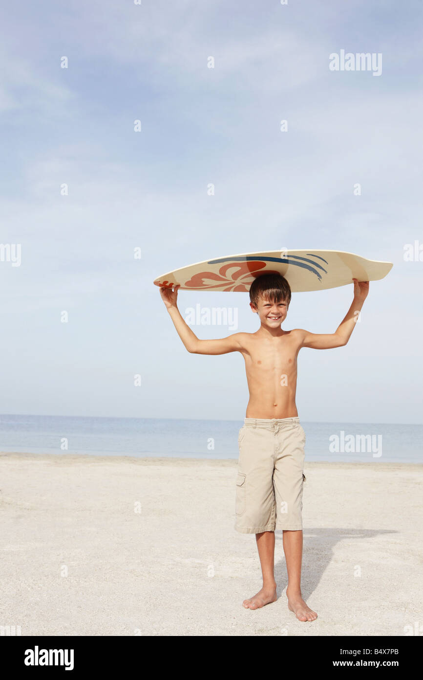 Boy holding skimboard on beach Stock Photo Alamy