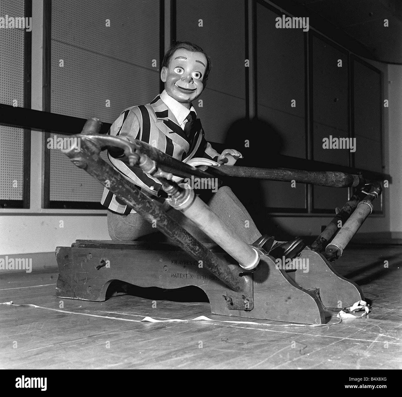 Archie Andrews 1958 ventriloquist s dummy on rowing machine Stock Photo
