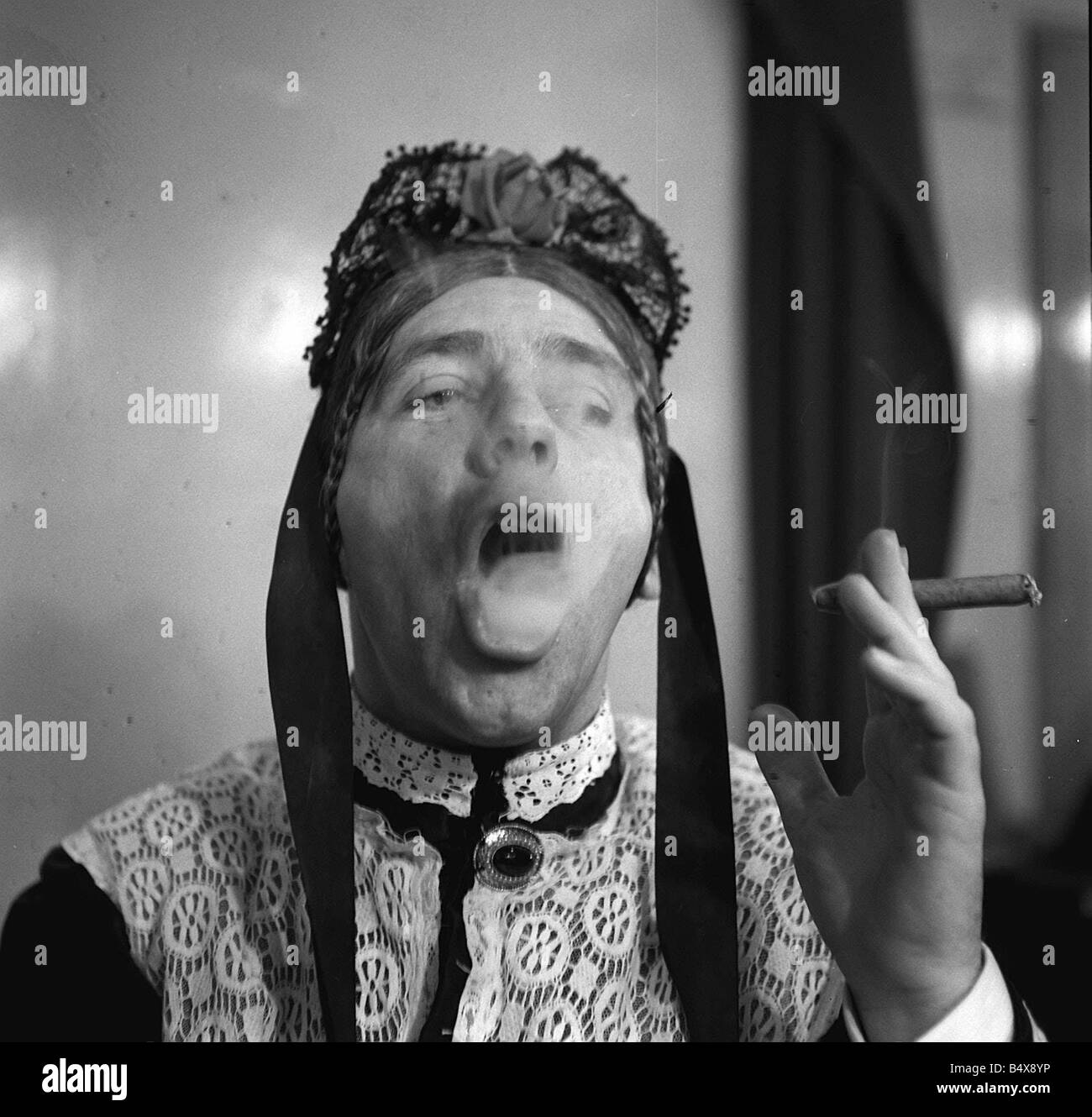 wisdom cigarette Norman Wisdom 1958 as Charley s Aunt for new musical version Where s  Charley smoking cigar blowing smoke rings Born in Paddingt Stock Photo