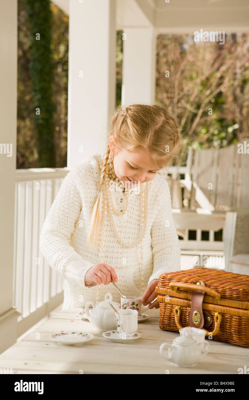 Girl having tea party on porch Stock Photo - Alamy