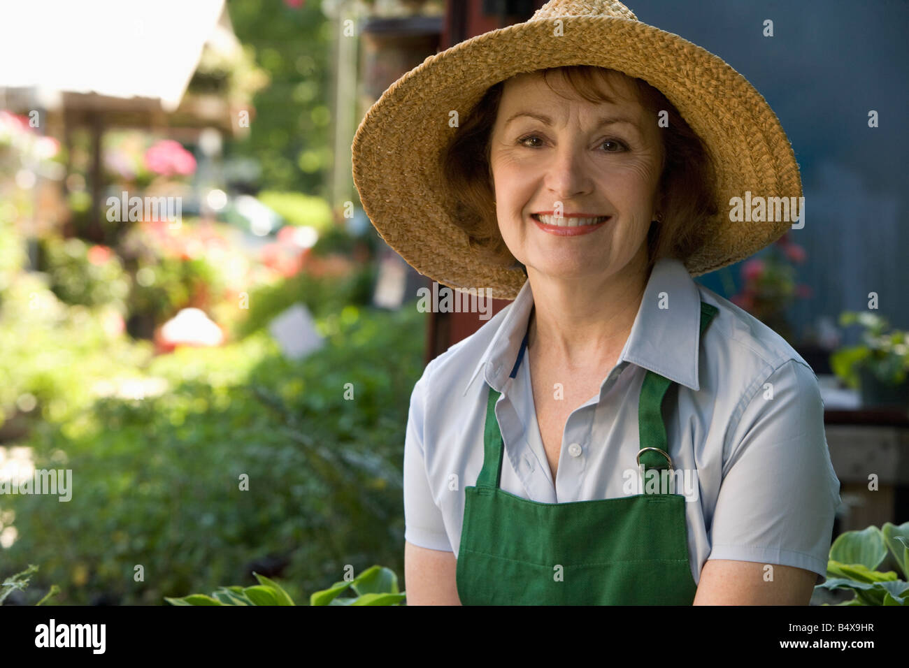 Woman working in garden center Stock Photo - Alamy