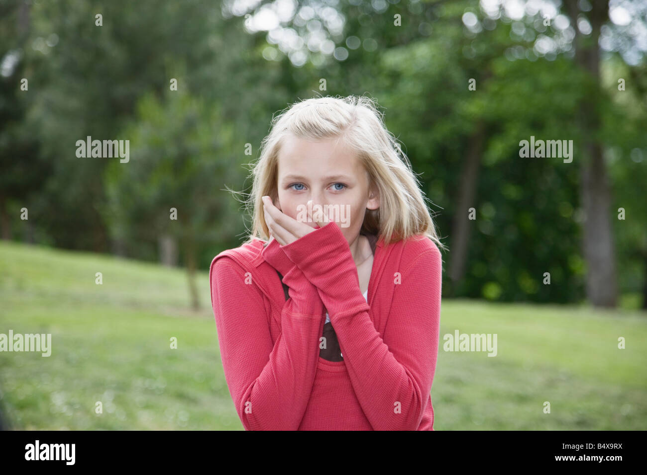 Girl blowing on cold hands Stock Photo Alamy