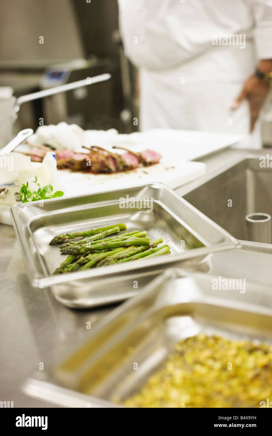 Chef preparing food in commercial kitchen Stock Photo Alamy