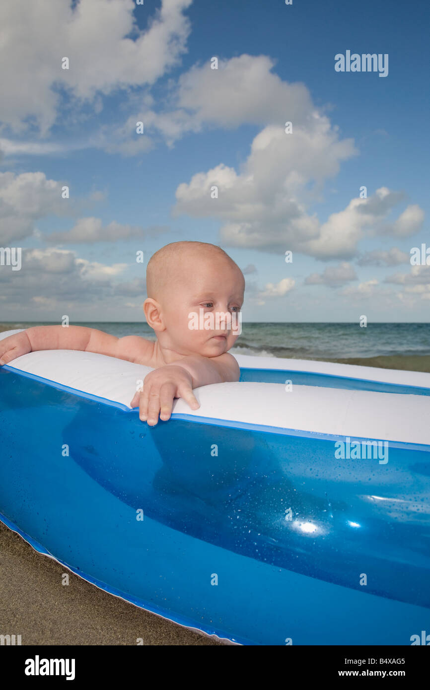 Baby boy sitting in inflatable swimming pool Stock Photo - Alamy