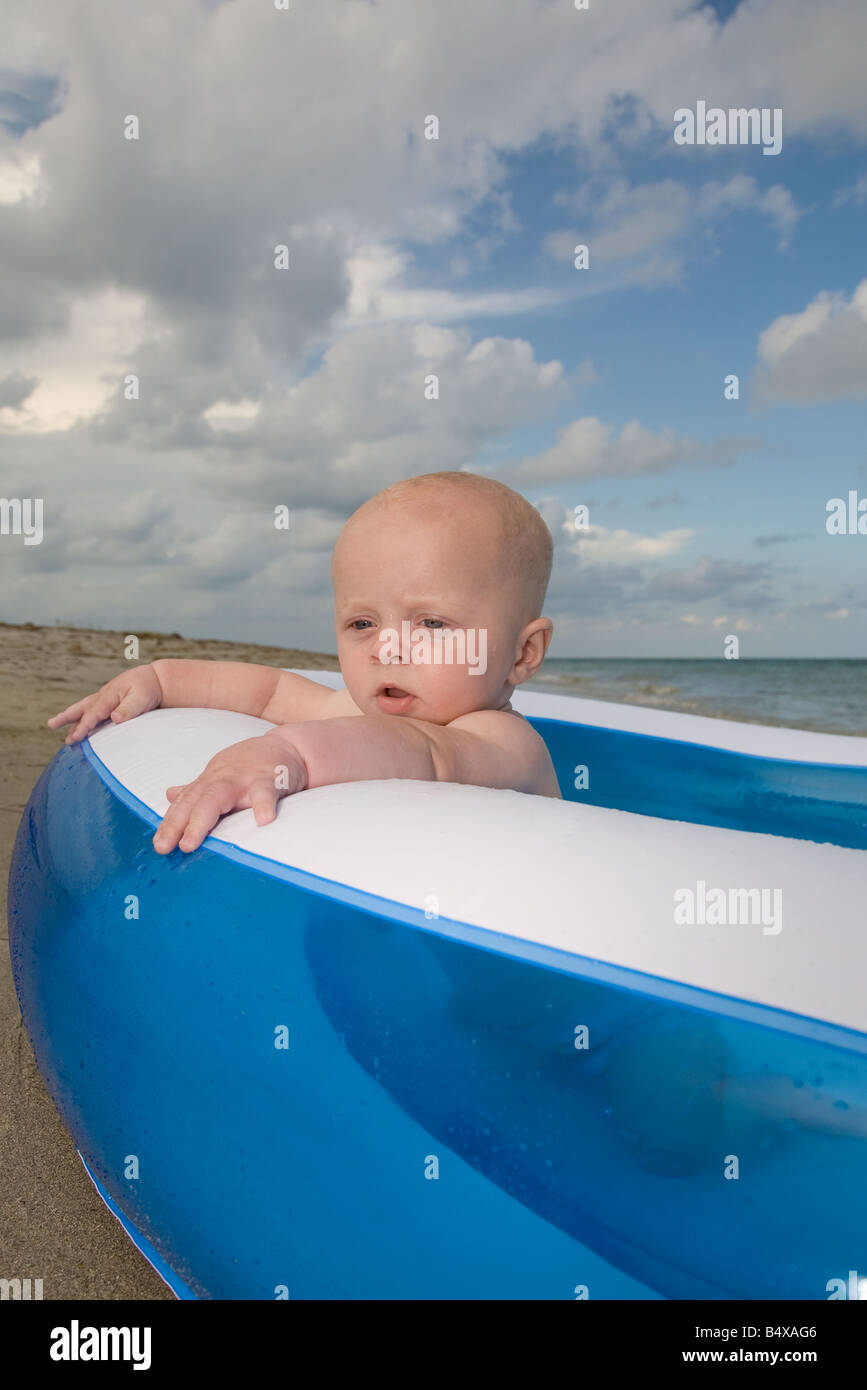 Baby boy sitting in inflatable swimming pool Stock Photo - Alamy