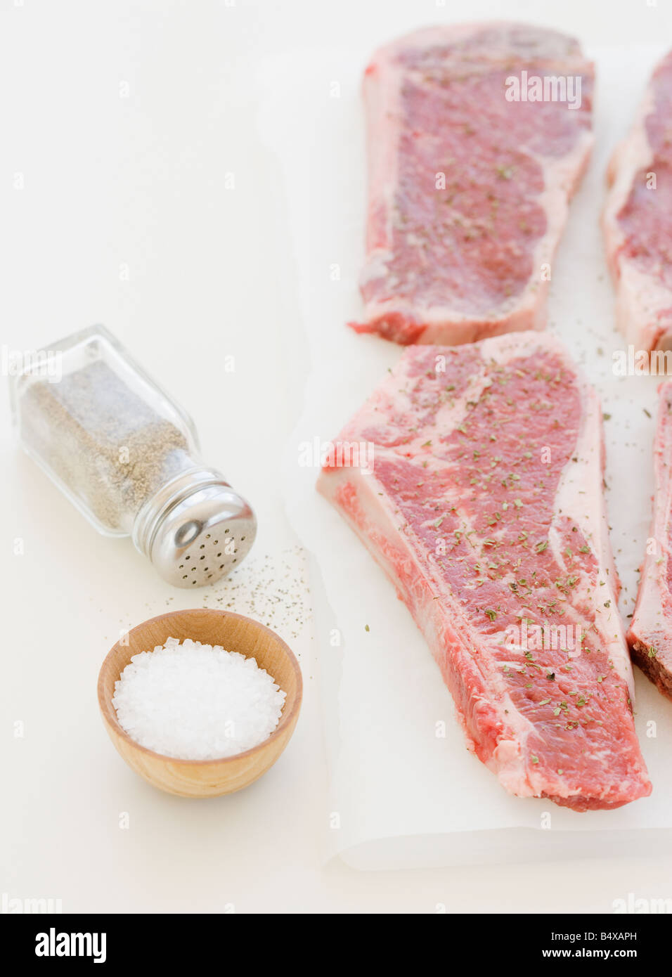 Close up of raw steaks and seasoning Stock Photo