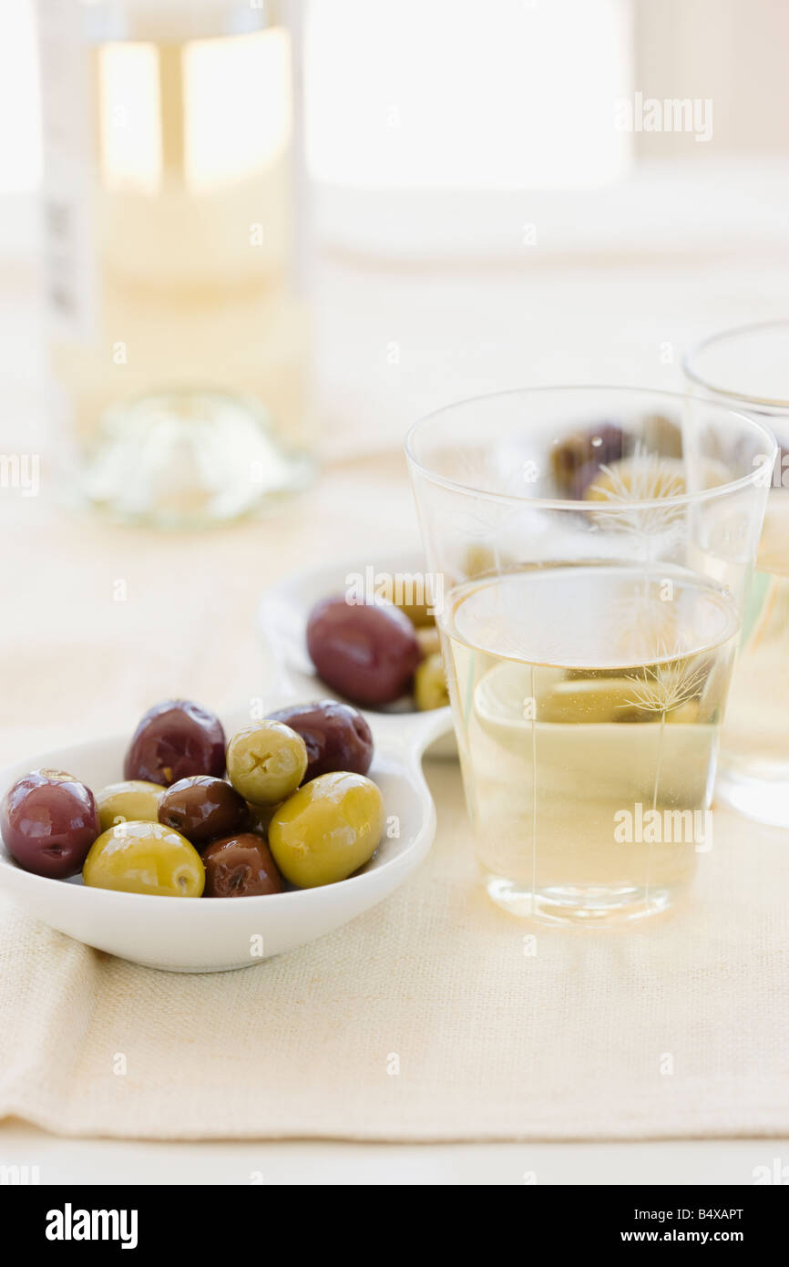 Serving bowl of assorted olives and wine Stock Photo
