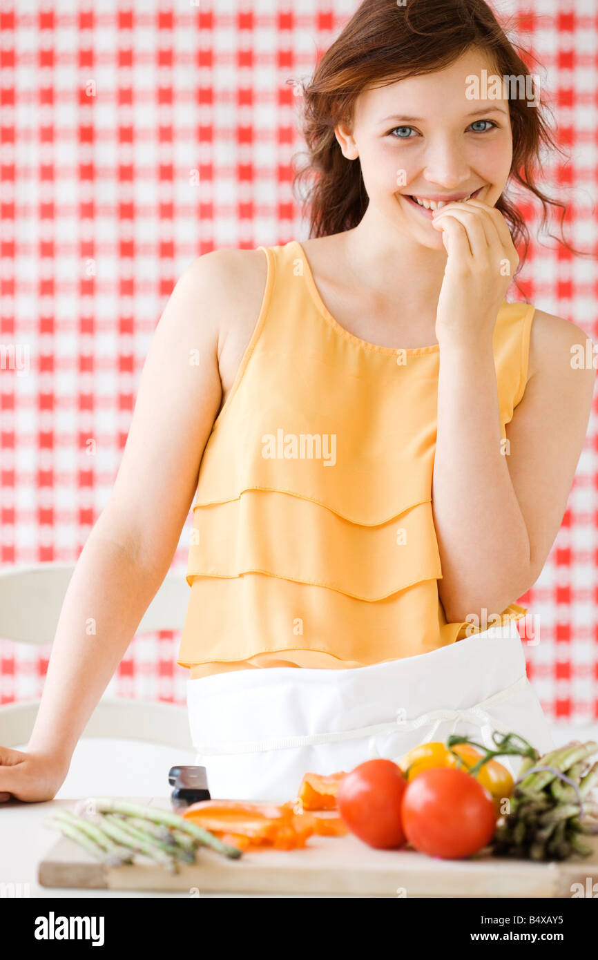 Teenage girl preparing fresh vegetables Stock Photo