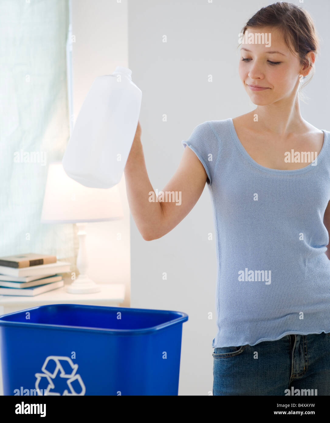 Teenage girl recycling milk jug Stock Photo Alamy