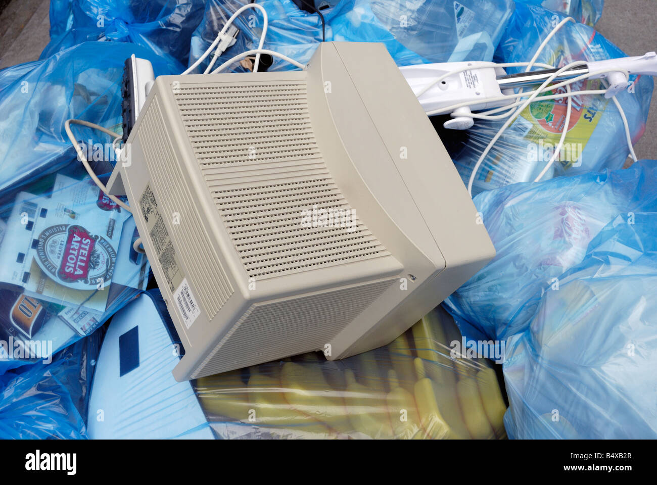 A discarded computer monitor sitting in a pile of trash on a New York