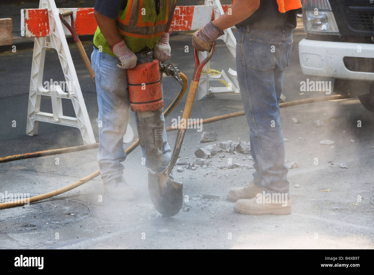 Construction workers using jackhammer and shovel Stock Photo Alamy